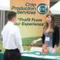A woman speaks to a male student at the Crop Production Services table at Ag Career Day.