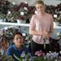 Students Brandon Franco and Emma Riley look over flowers on display at flower show.