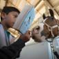 Mark Me Famous tries to get a closer look at the book, The Black Stallion, as 4th graders from Kellogg Elementary School read to horses.