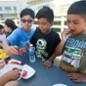 School children sampling Cal Poly Pomona-grown fruits and vegetables