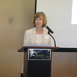 Professor Emerita Betty Tracy, one of AMM's founders, speaks at the event