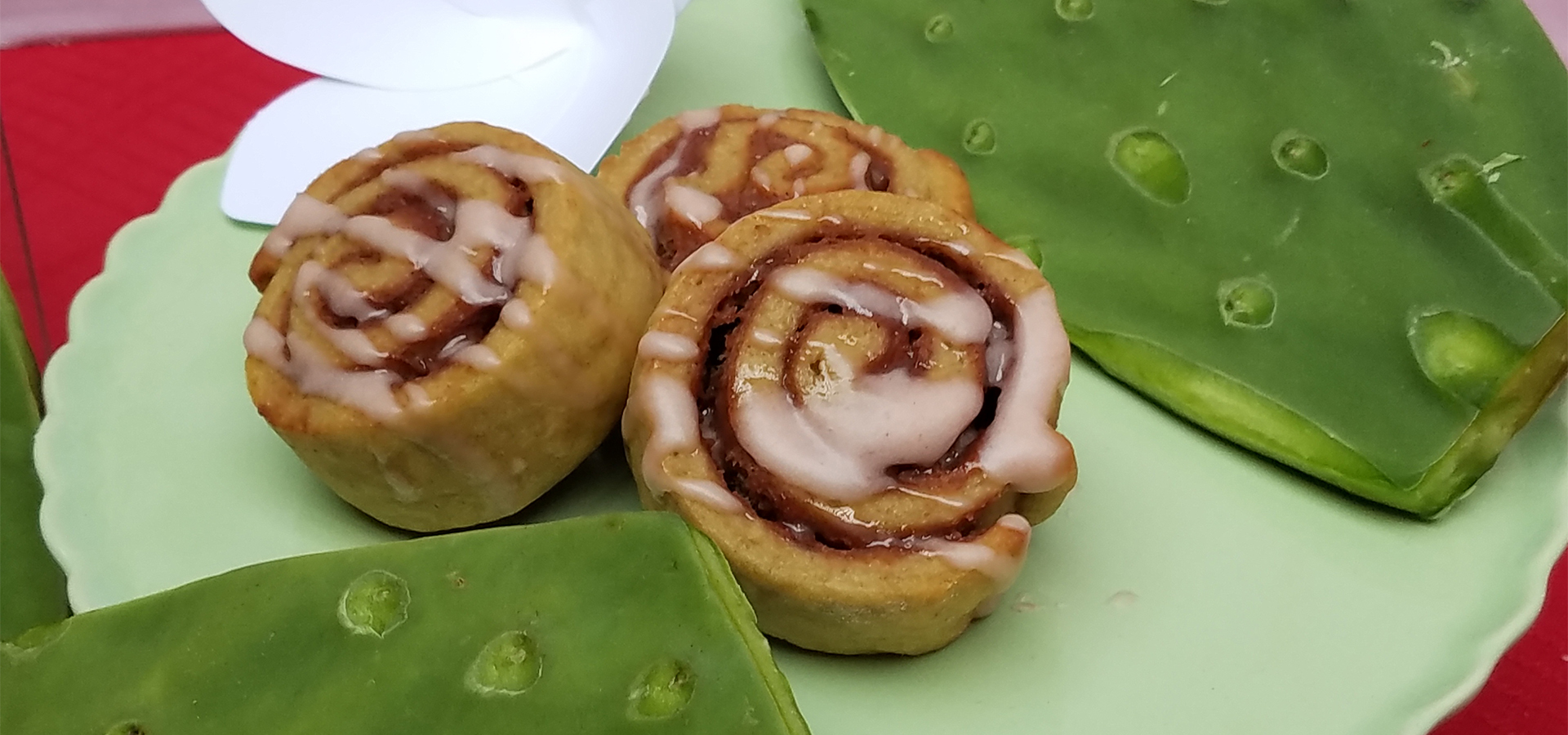 A green plate with a trio of Upswirlz, which look like mini cinnamon rolls