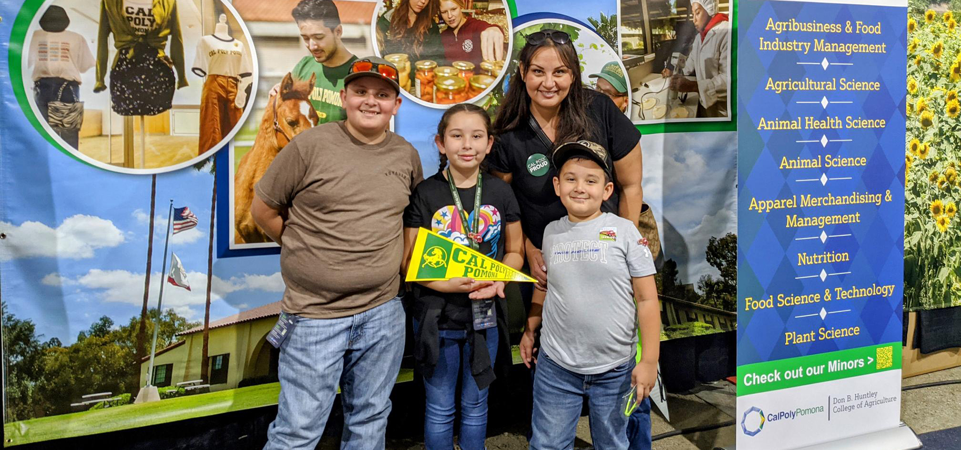An alumna visits the Huntley College of Agriculture booth at World Ag Expo 2022 with her children.