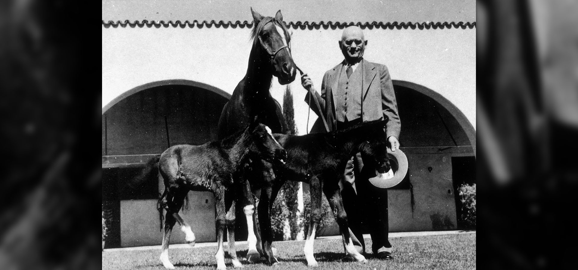 W.K. Kellogg poses with horse and two foals
