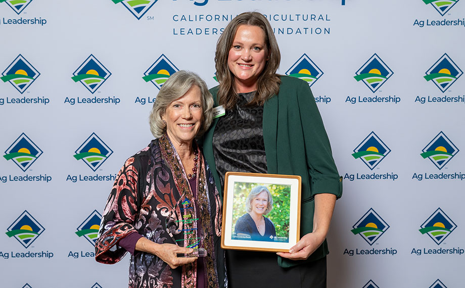 Peggy Perry posing with her award and another woman.