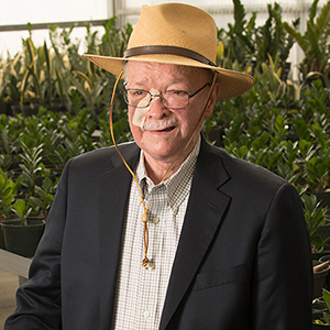 Richard Frencer poses for a 2017 photo in the Cal Poly Pomona nursery greenhouse