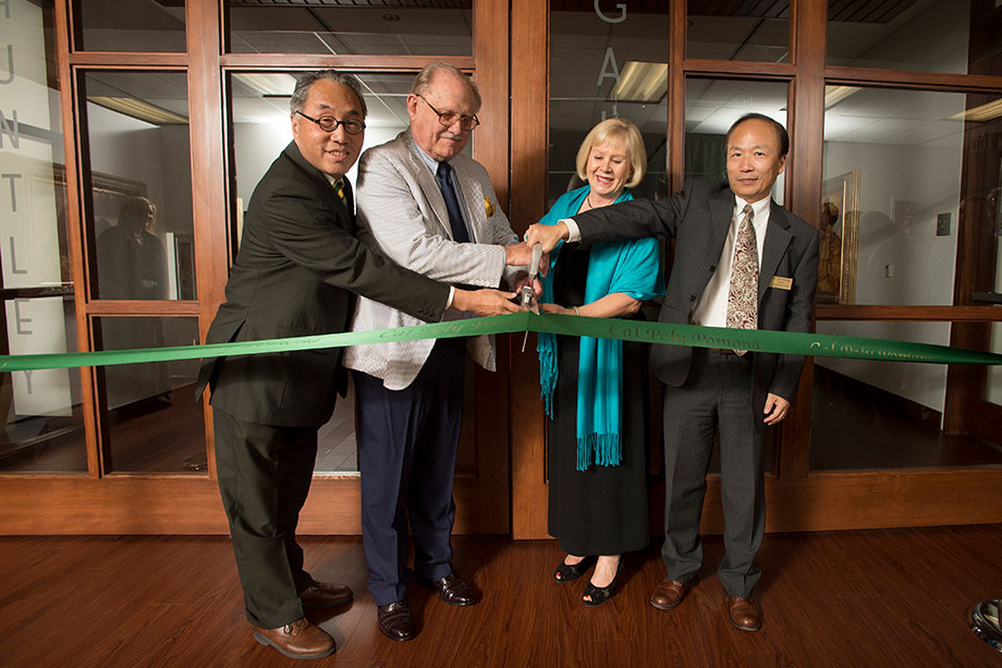 Don B. Huntley and others cutting a ribbon.