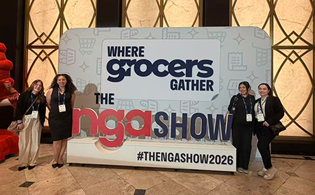 Four women pose next to the NGA Show sign.