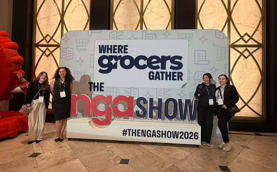 Four women pose next to the NGA Show sign.