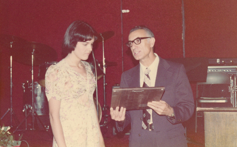A man presents an award to a woman.