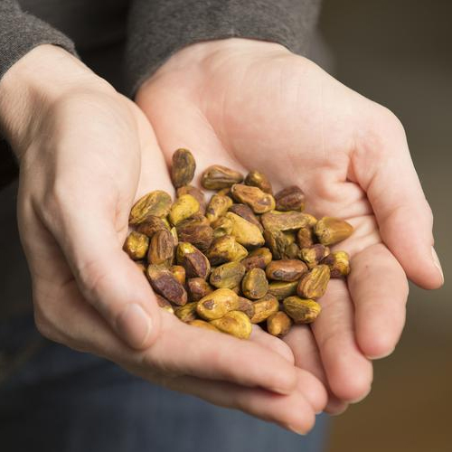 a student holds a handful of pistachios