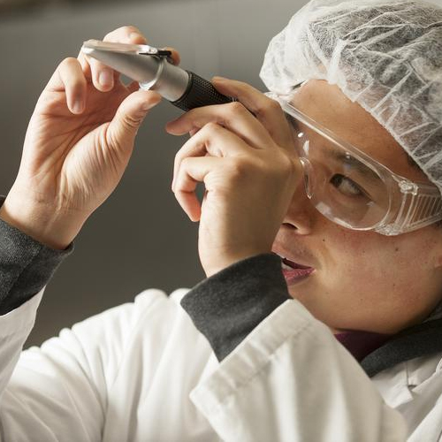 student checks sugar content of orange juice