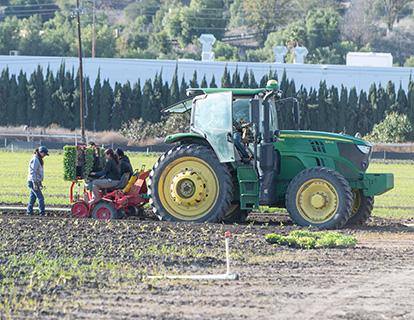 Students use a tractor to plant at Spadra Farm.
