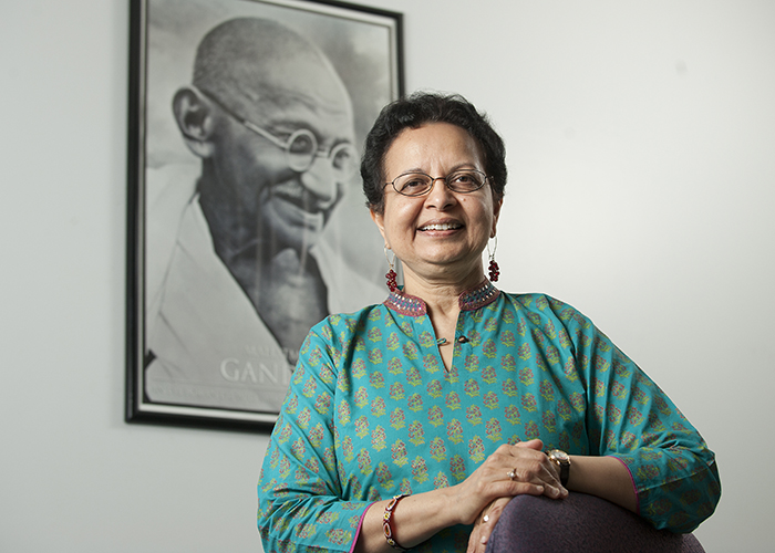Dr. Tara Sethia in front a framed picture of Ghandi