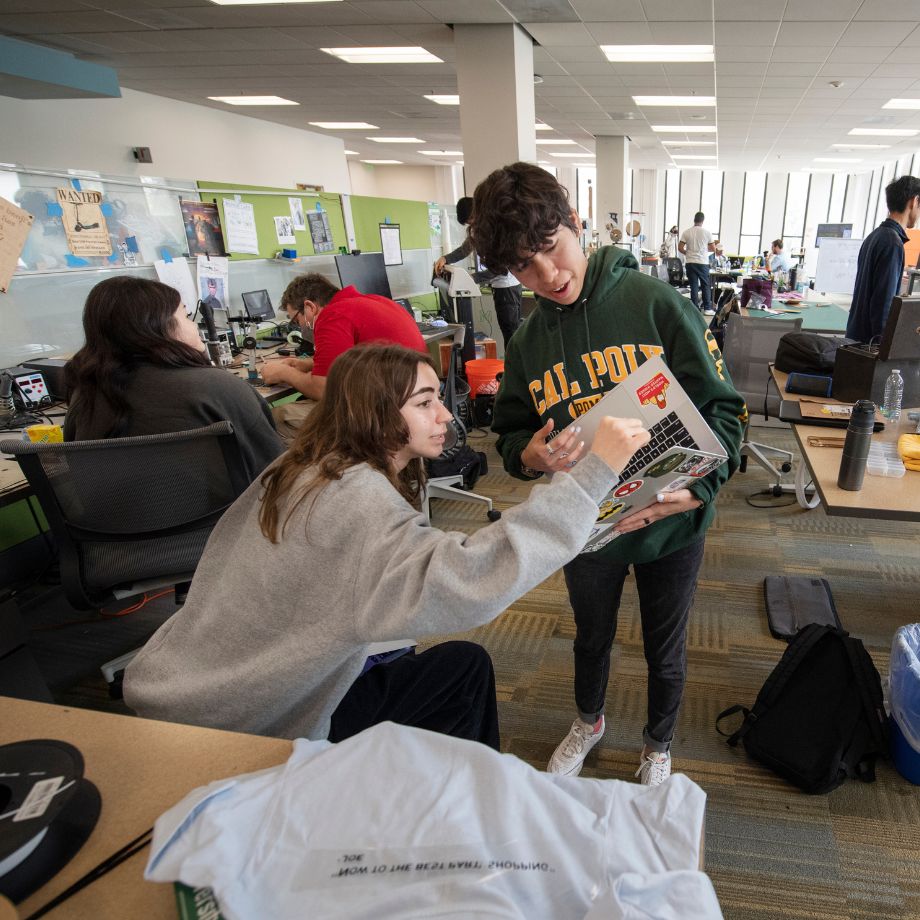 student sharing with another student designs