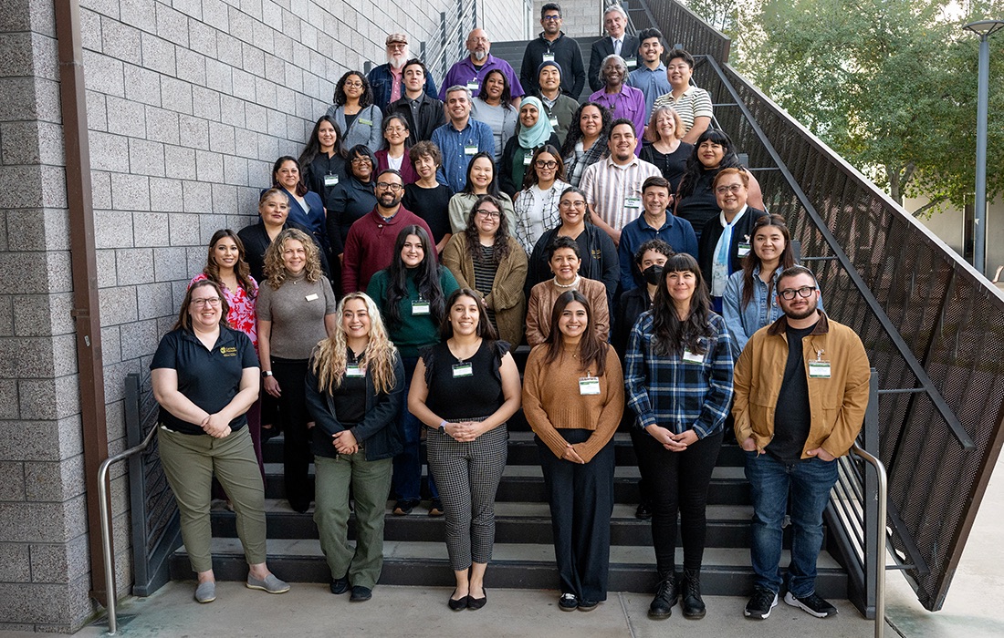 OAI Department standing all together on stairs smiling