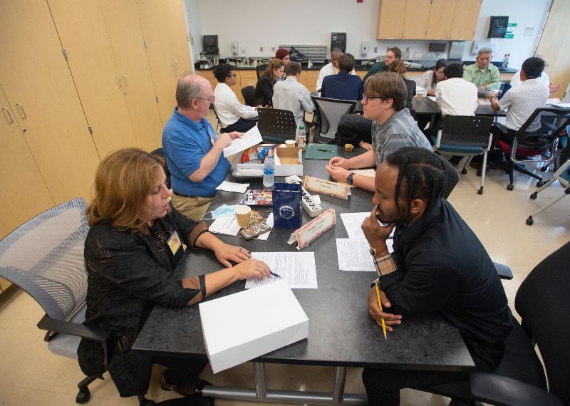 Students engage in a career development session, networking and discussing professional growth.