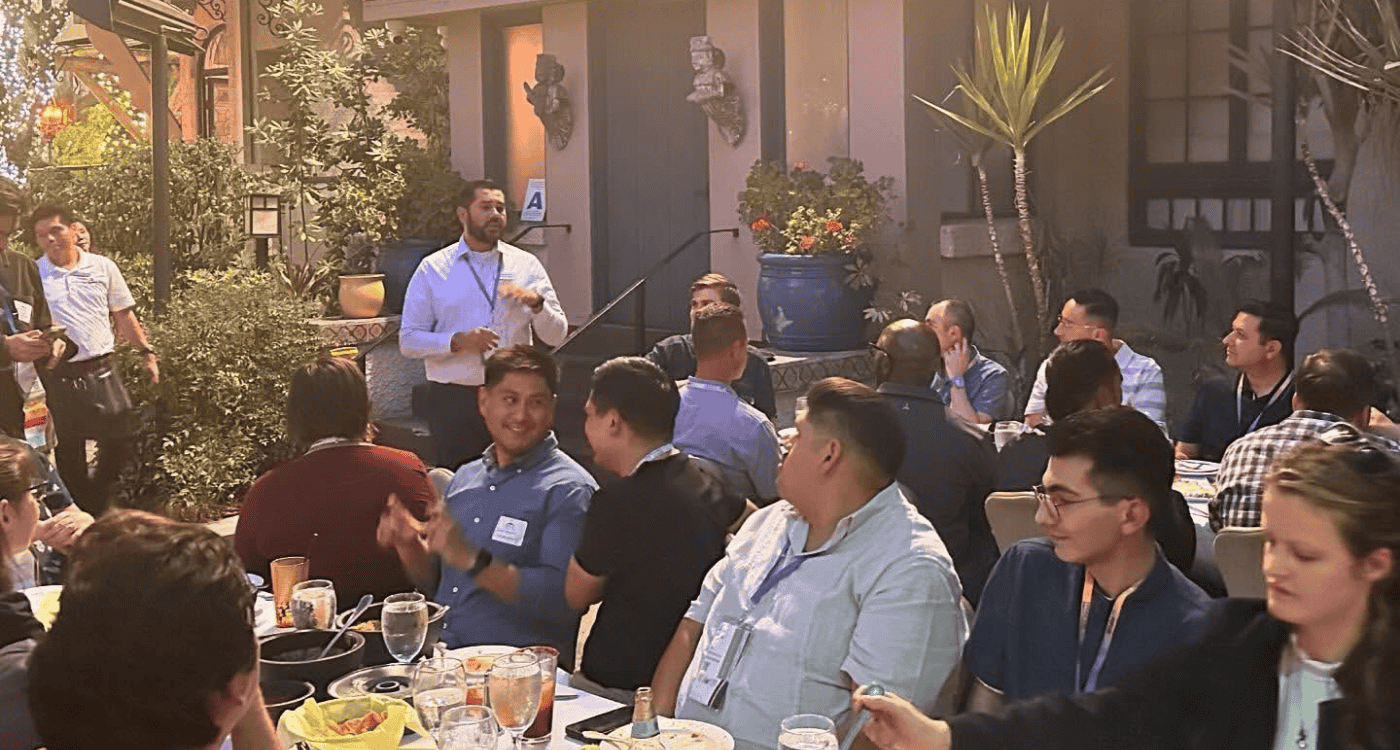 alumni manuel munoz presenting to alumni at mixer