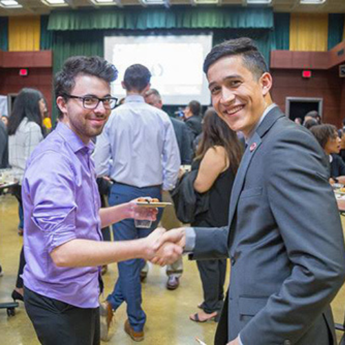 two students shaking hands