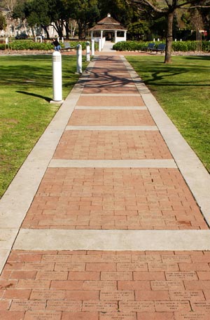 Pathway to the rose garden where alumni bricks are placed into the ground in the rose garden.