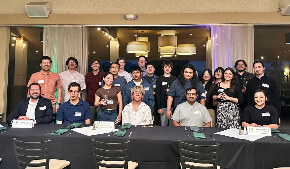 students and alumni sitting at dinner table