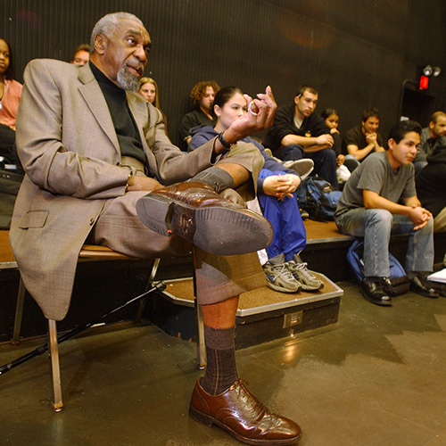 Professor for a day alumnus  speaking in a theater class.