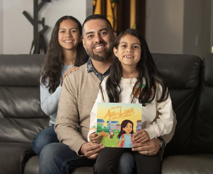 Chris Sandoval with his two daughters