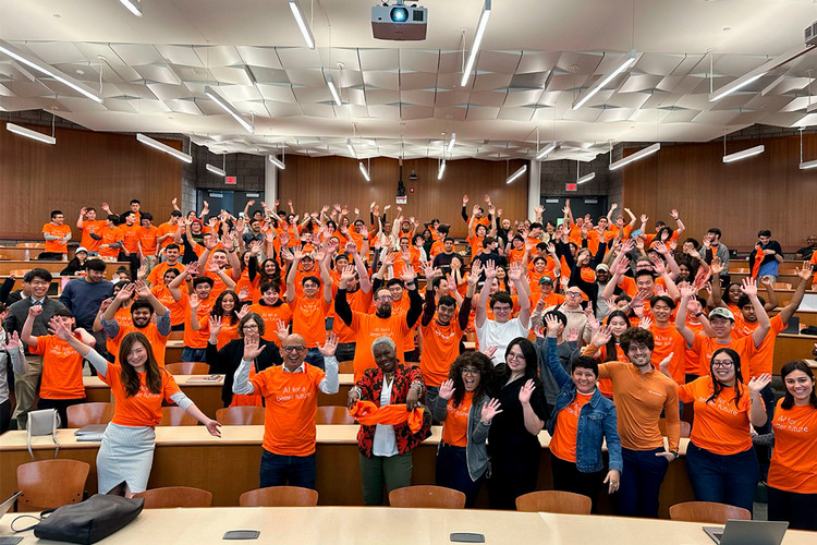 people gathered for a group photo in a large lecture hall