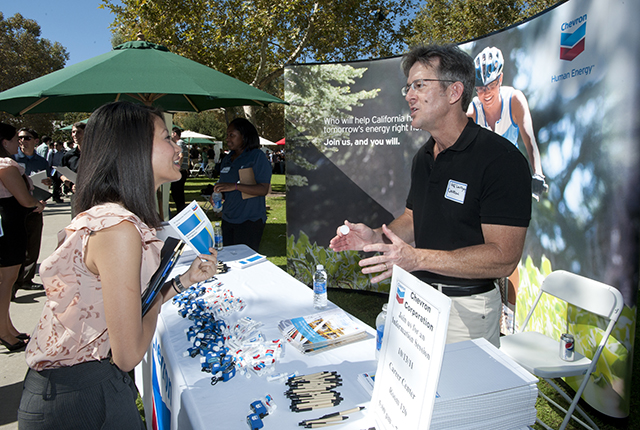 booth attendant during career fair giving information