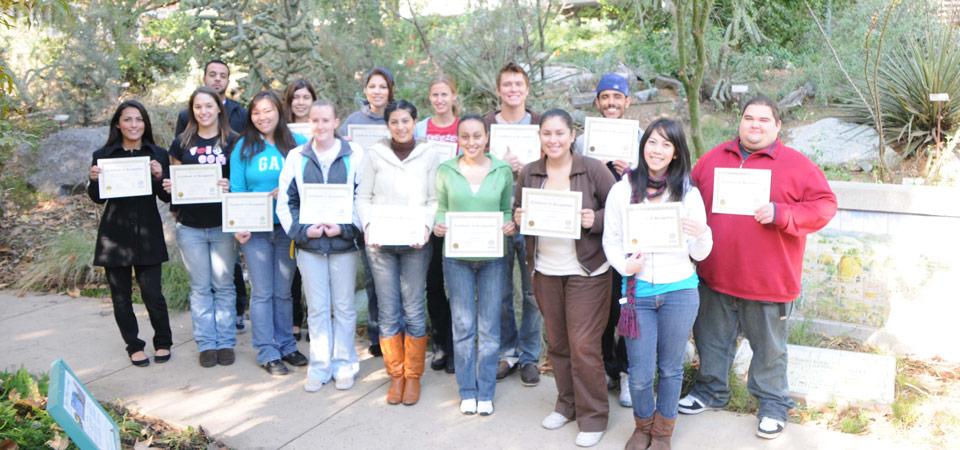 Service-Learning students holding certificates