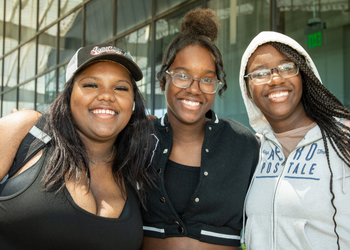 Three students pose for the camera