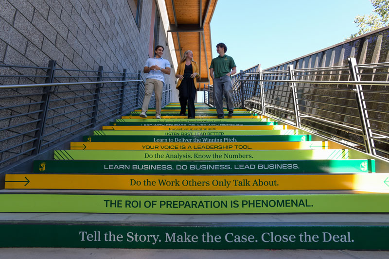 Students walking down College of Business Administration stairs to success