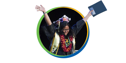 student celebrates in graduation hat and gown