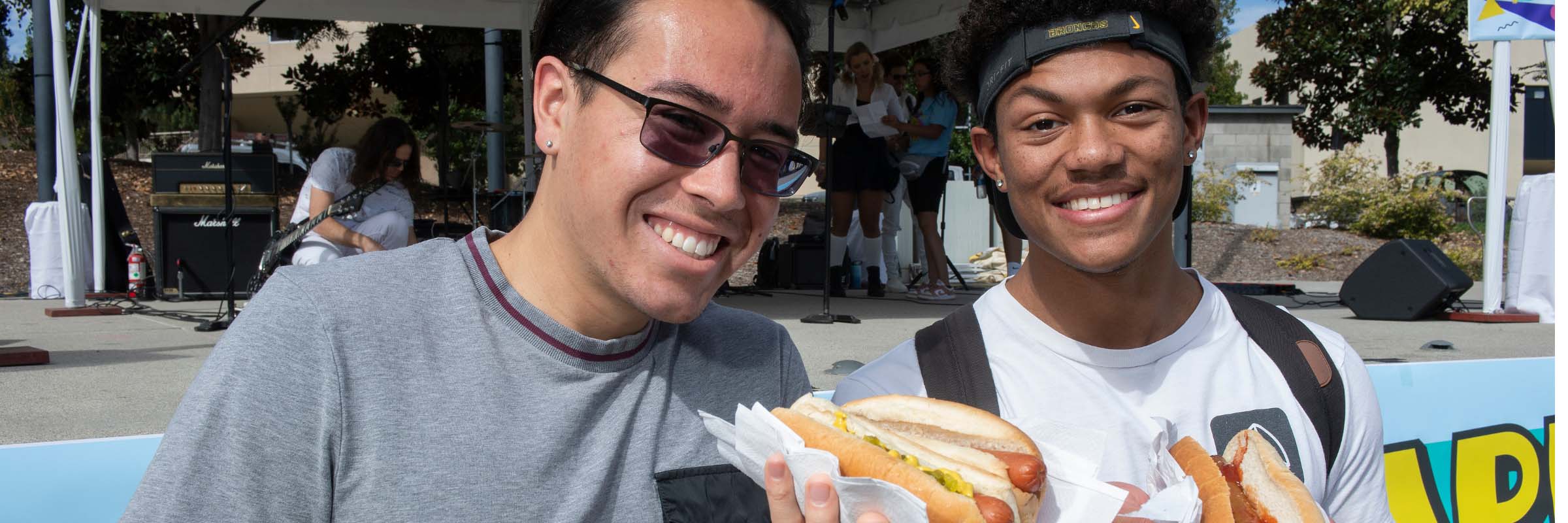 Students pose with their free hot dogs at the Caper