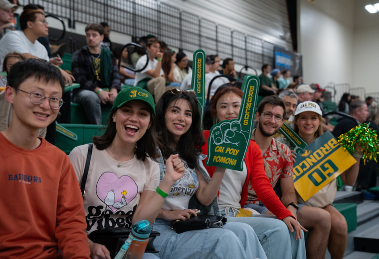 Students in CPP gear pose for the camera at an Athletics game