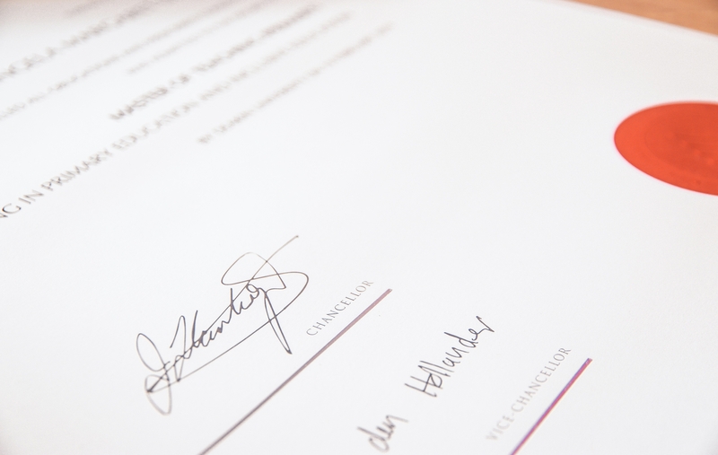 Closeup image of pen writing on notepad