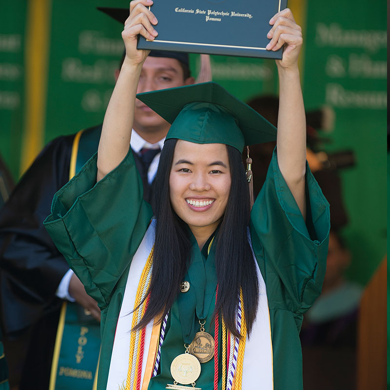 2014 McPhee Scholar holding degree over her head at Commencement 