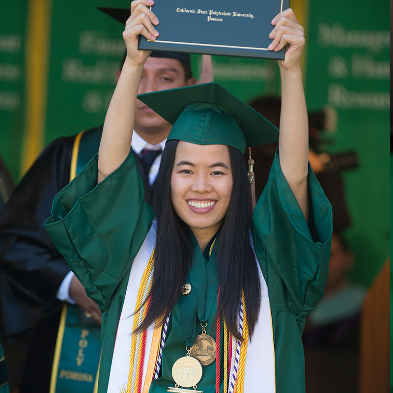 2014 McPhee Scholar holding degree over her head at Commencement