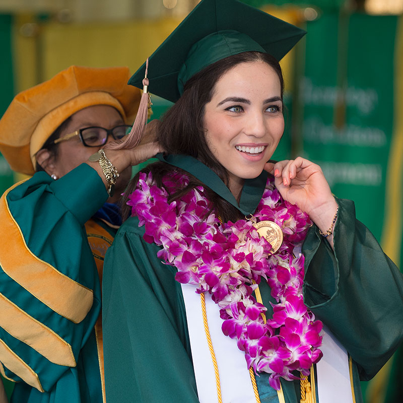 2015 McPhee Scholar on stage at Commencement with President Coley