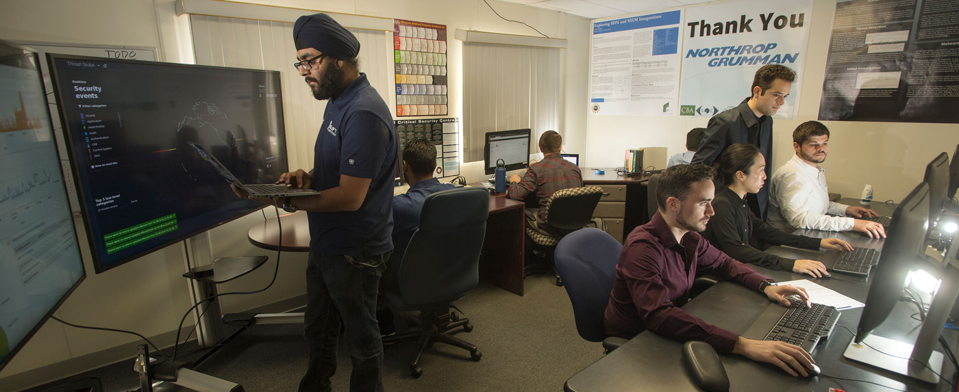 Cybersecurity students in lab working on computers