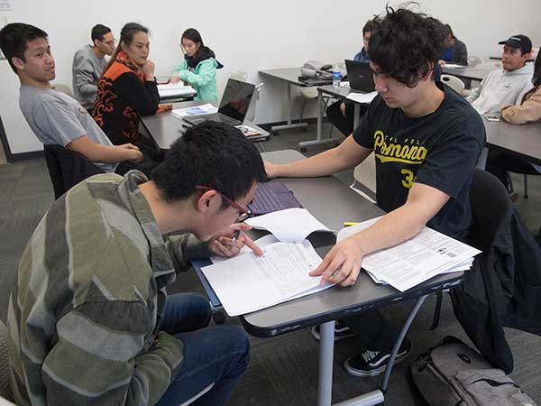 Student helping prepare taxes for community member during VITA