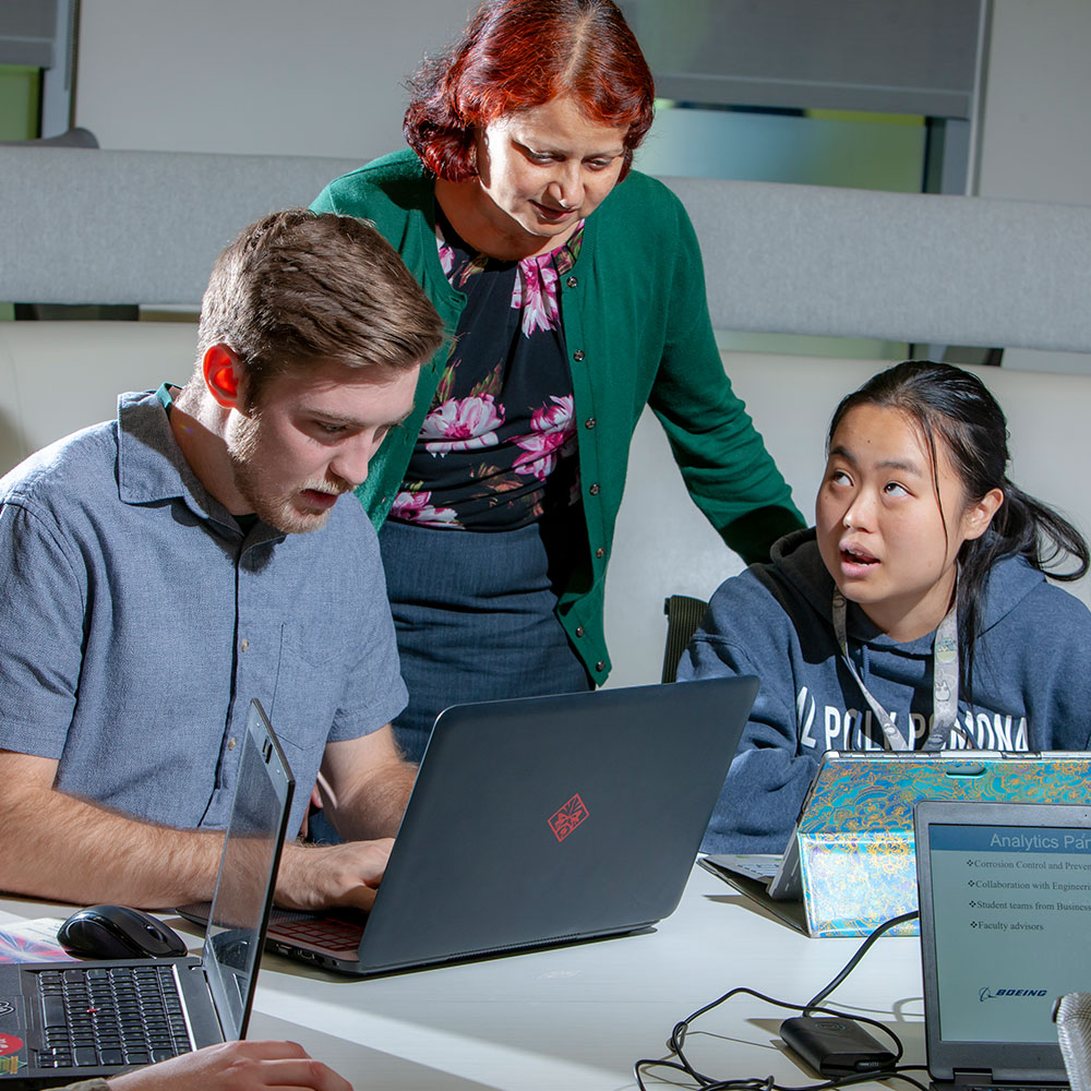 Professor working with students on Boeing analytics project 