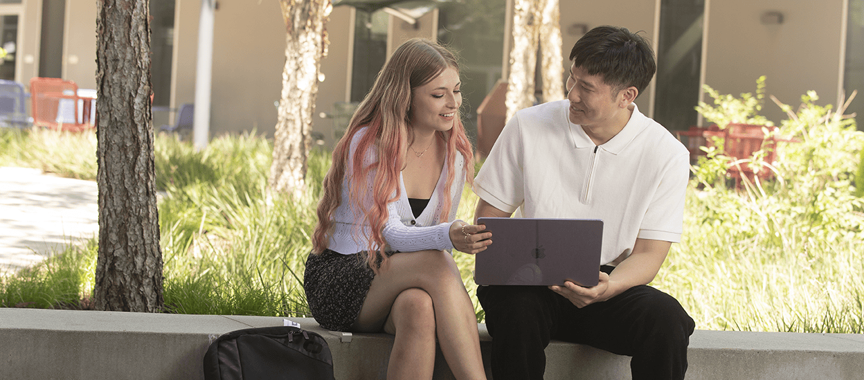 Students in CBA courtyard studying 