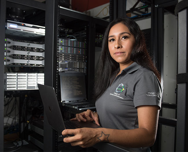 Female student with laptop in SWIFT data center