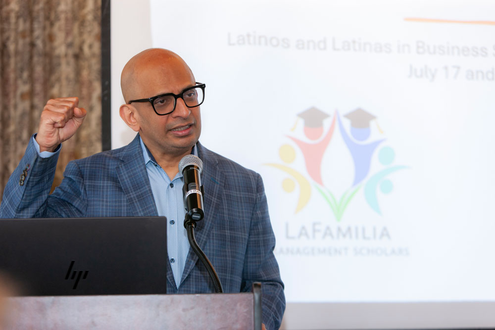 Dean Krishnamurthy welcomes guests to La Familia Conference