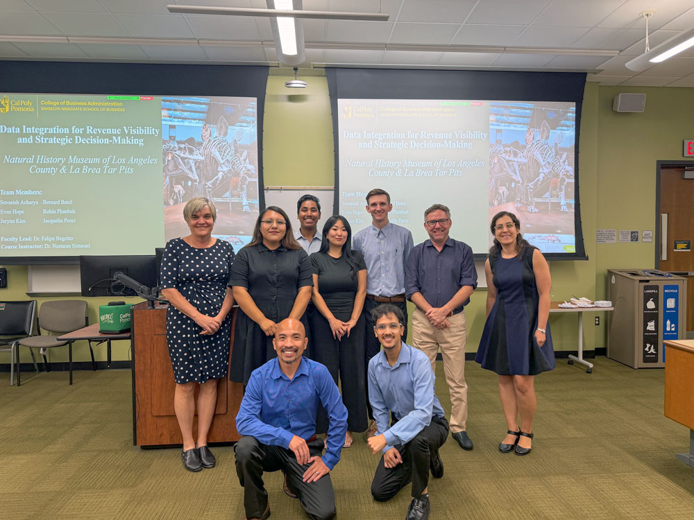 Group photo of MSBA students and professor after presenting data