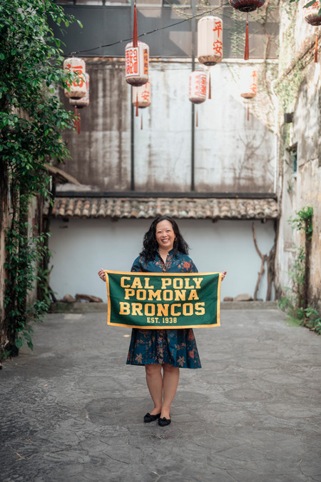 Lin Ong holding Cal Poly Pomona banner
