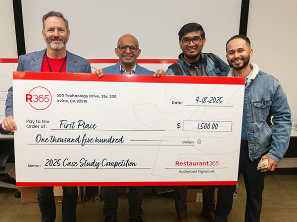 Students holding check at Restaurant 365 Case Competition 