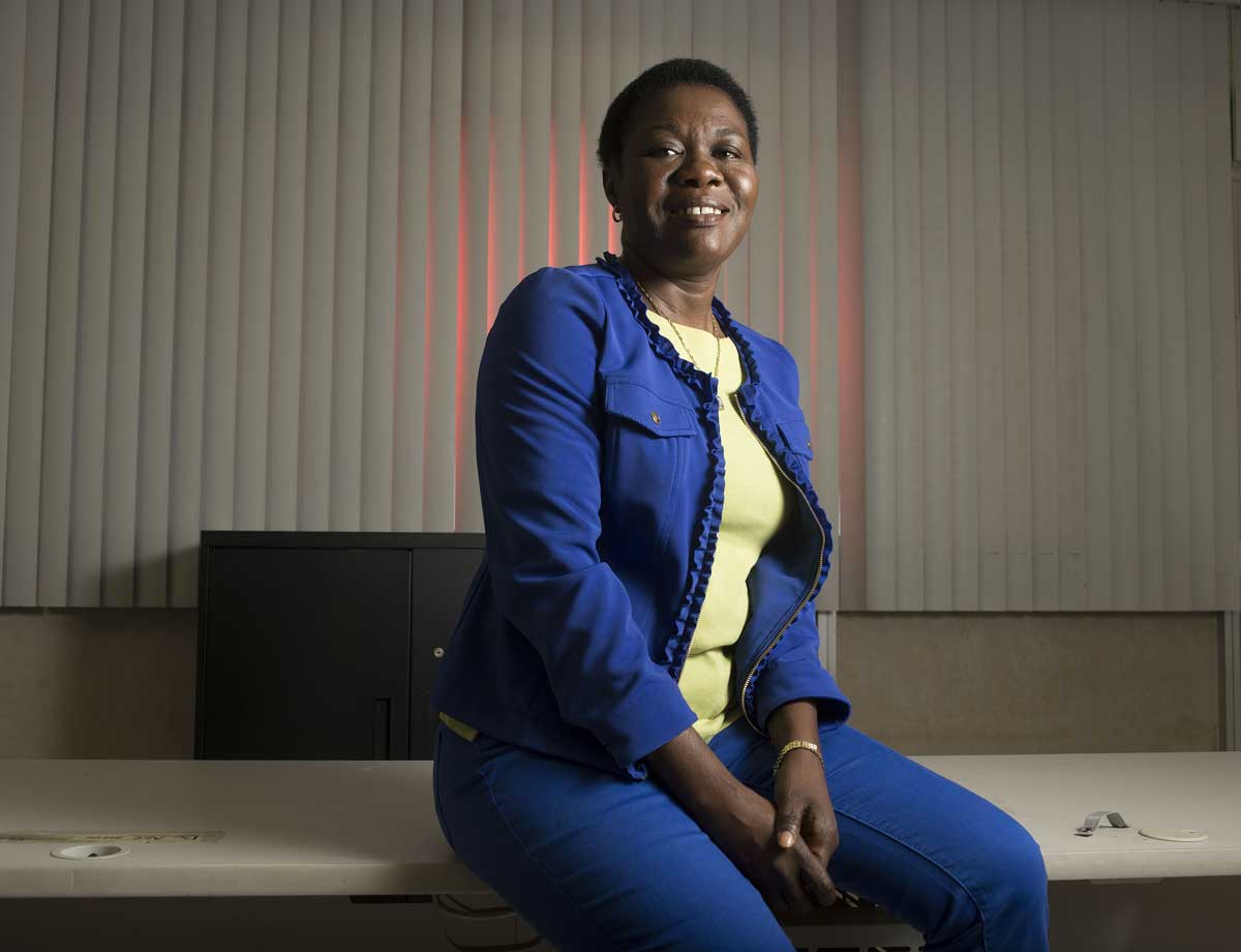 Olukemi sitting on table posing for picture