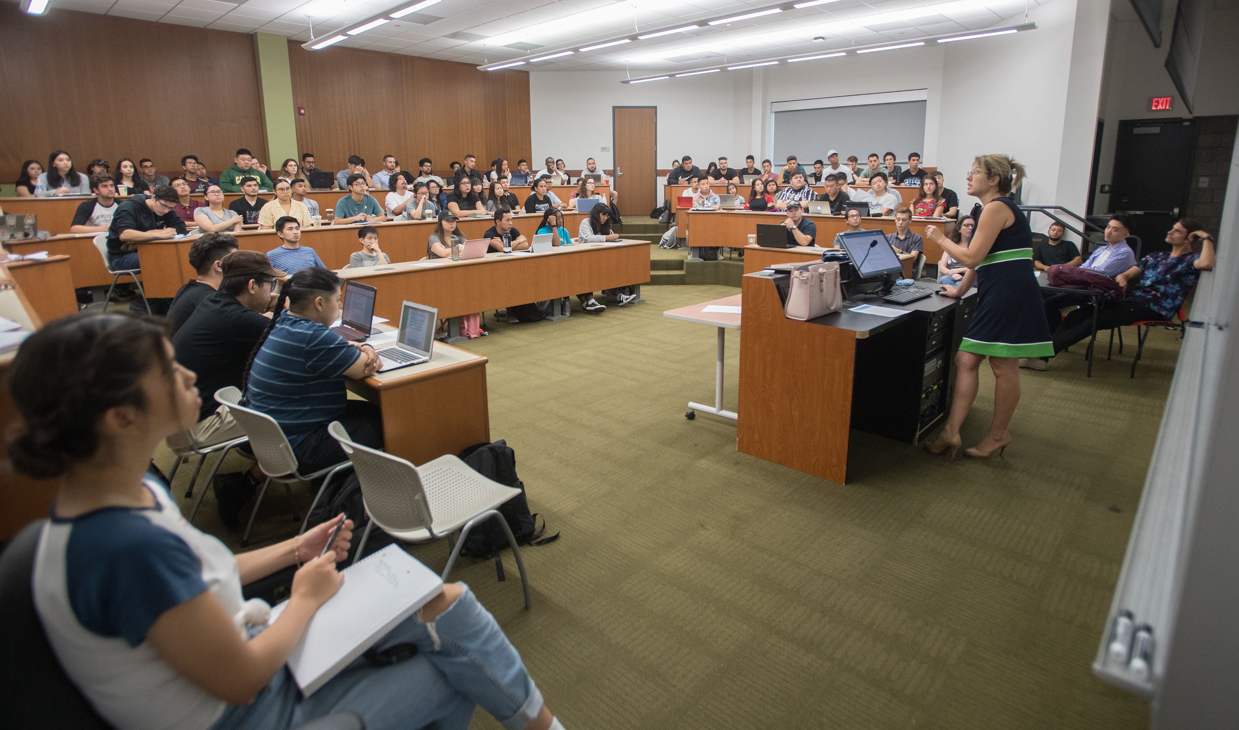 Students in class listening to professor lecture